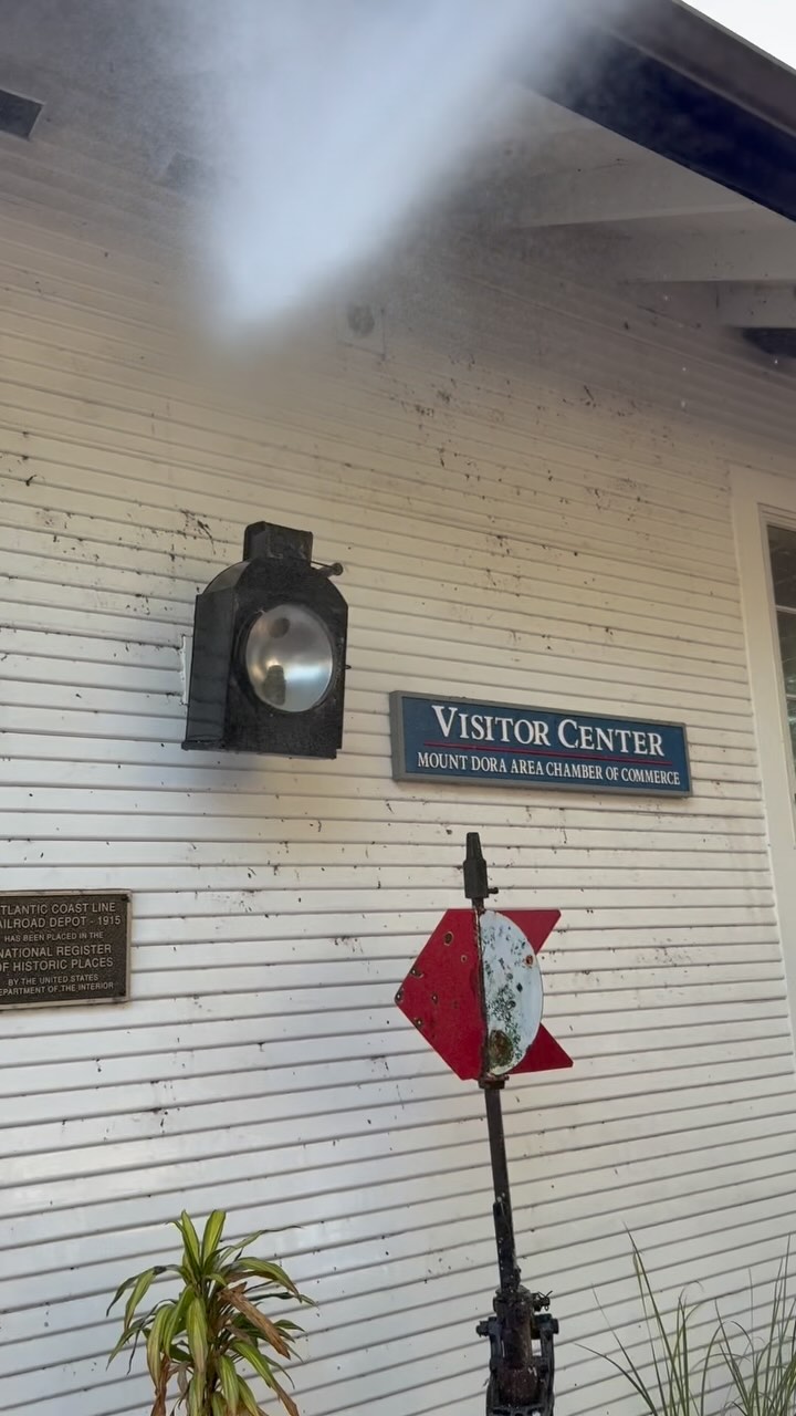 Handy Honey Bunny washing the exterior of the Mount Dora visitor-center building